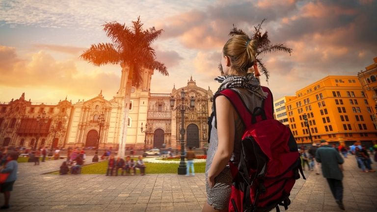 a female backpacker in Lima with people in the main plaza of the colonial city