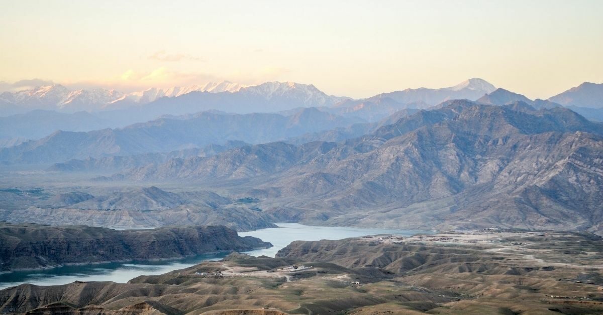 aerial view of mountain landscape and river in Afghanistan with snow caps in background