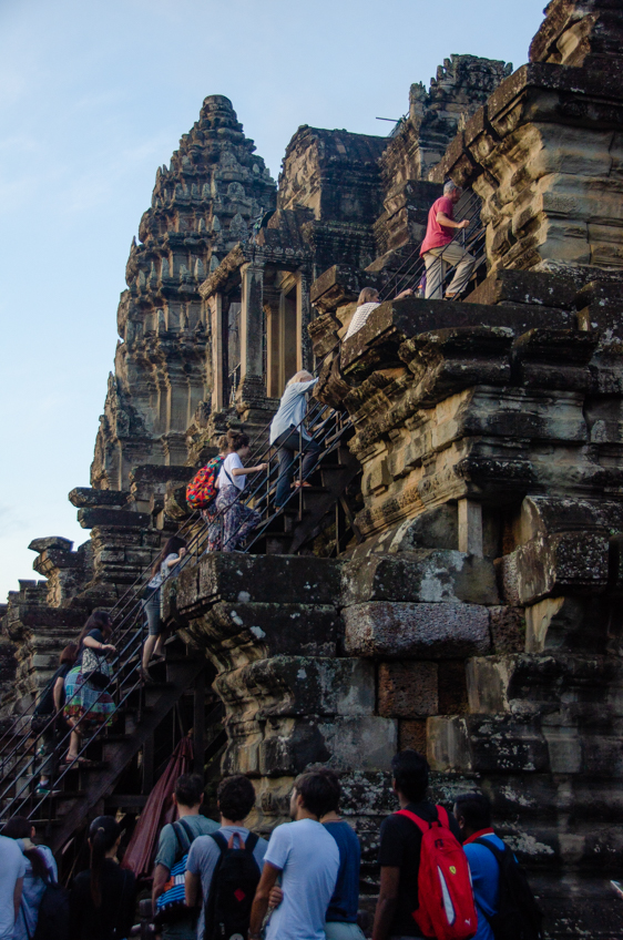 too many tourists climbing steep stairs at Angkor Wat