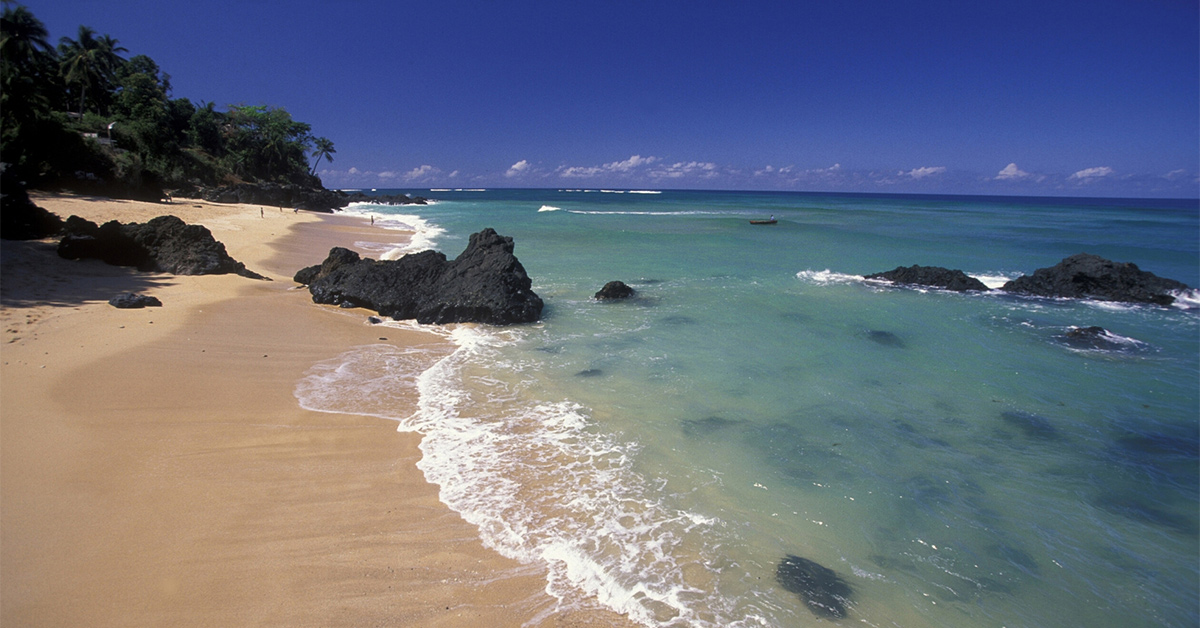 sandy beach with large rocks and turquoise waters in Anjouan, Comoros on a sunny day