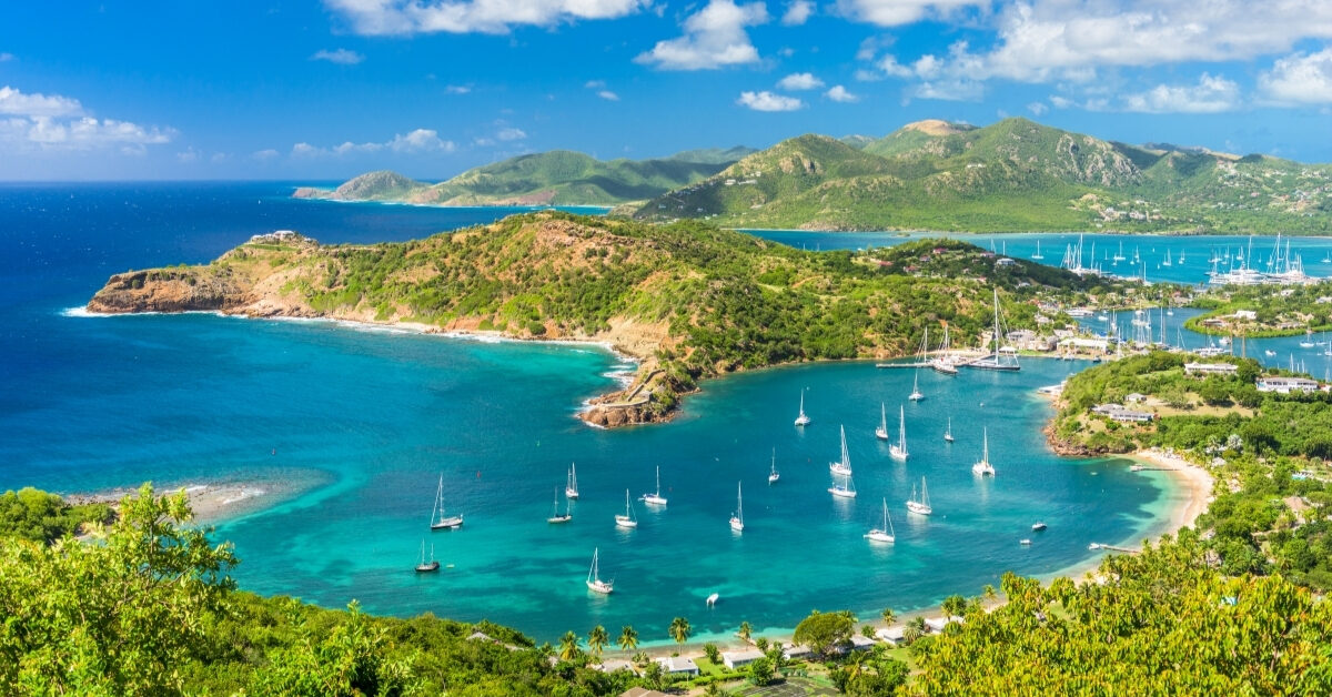 bird's eye view from Shirley Heights on Antigua island with mountains and hills and boats in the four harbors