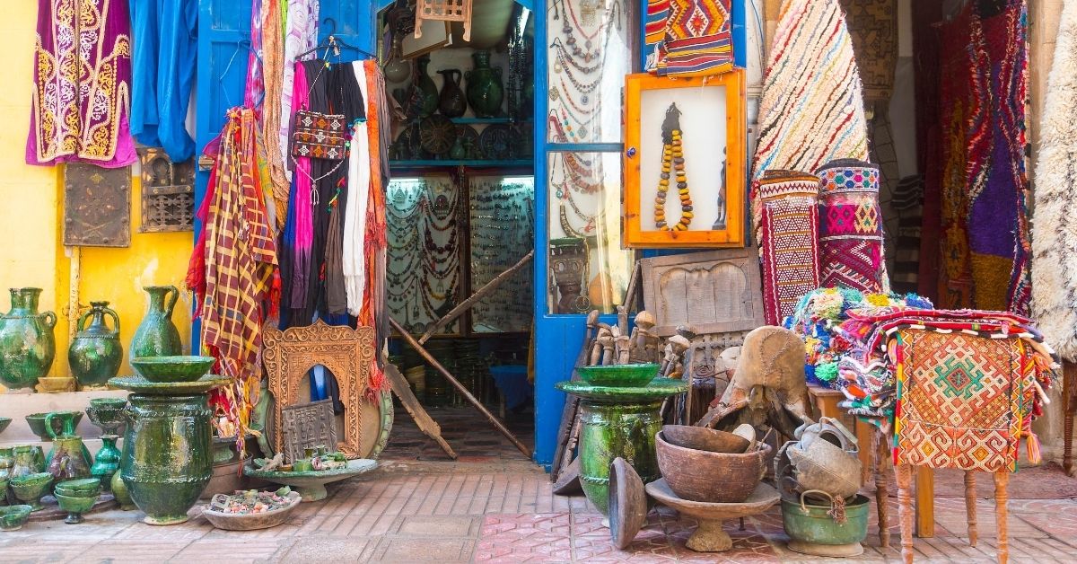 In Africa, colorful shop exterior with dispalyed earthenware and Moroccan fabrics, art and handicrafts
