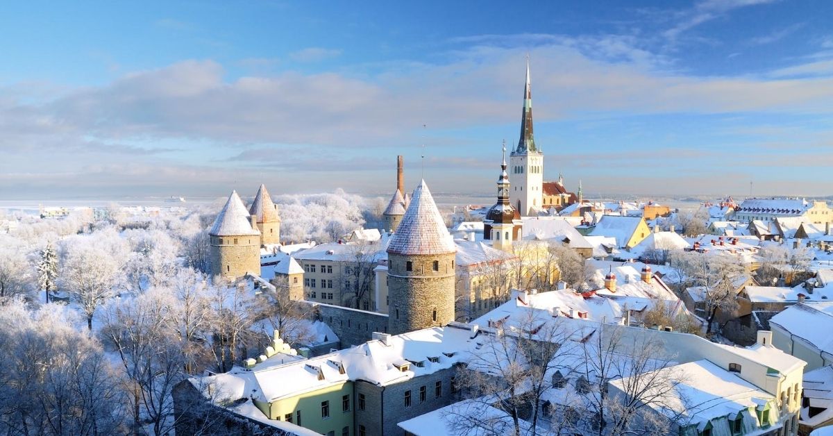 skyline of Tallinn, Estonia with snow covered trees and blue skies