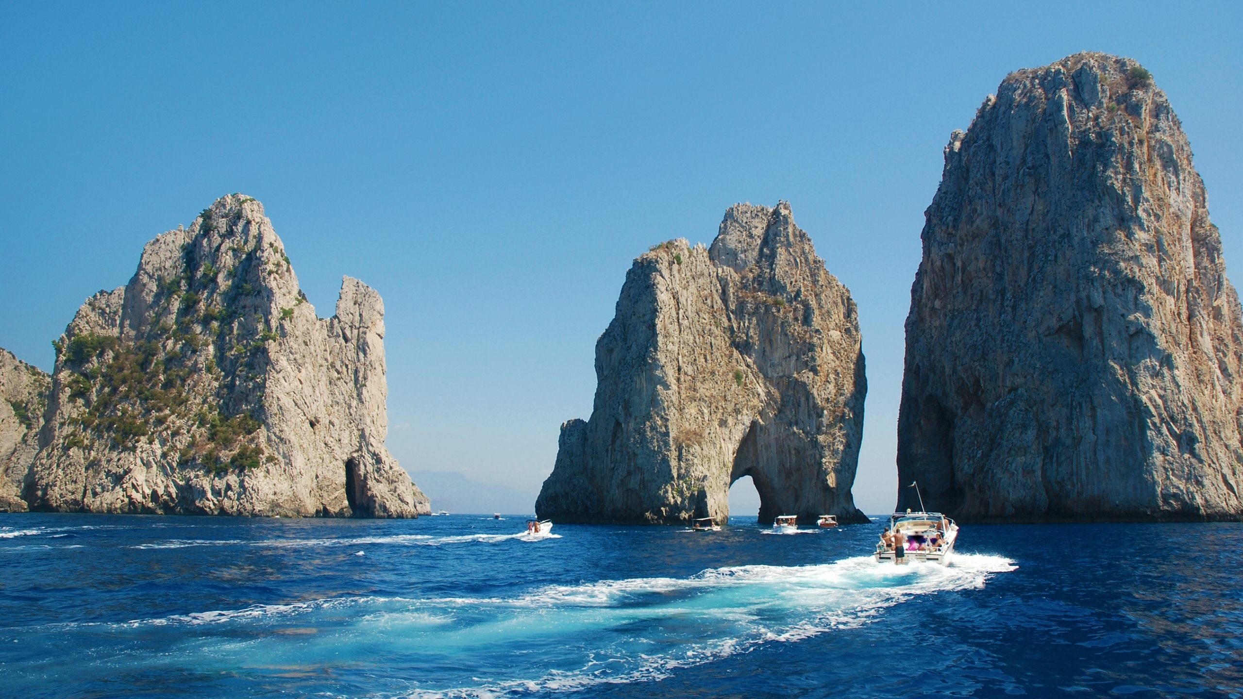 Faraglioni rocks in Capri with boats