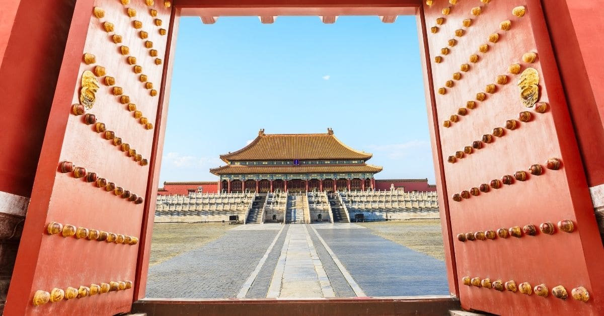 Red doors frame the view of the The Forbidden City in Beijing