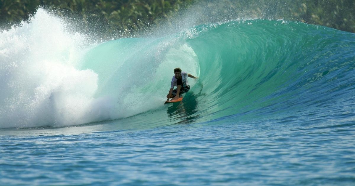 surfer riding a barrel wave