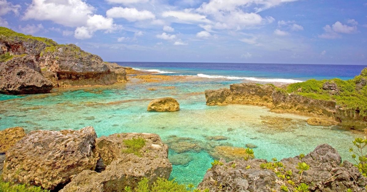 natural pool formed by the Pacific with rocky cliffs and coral