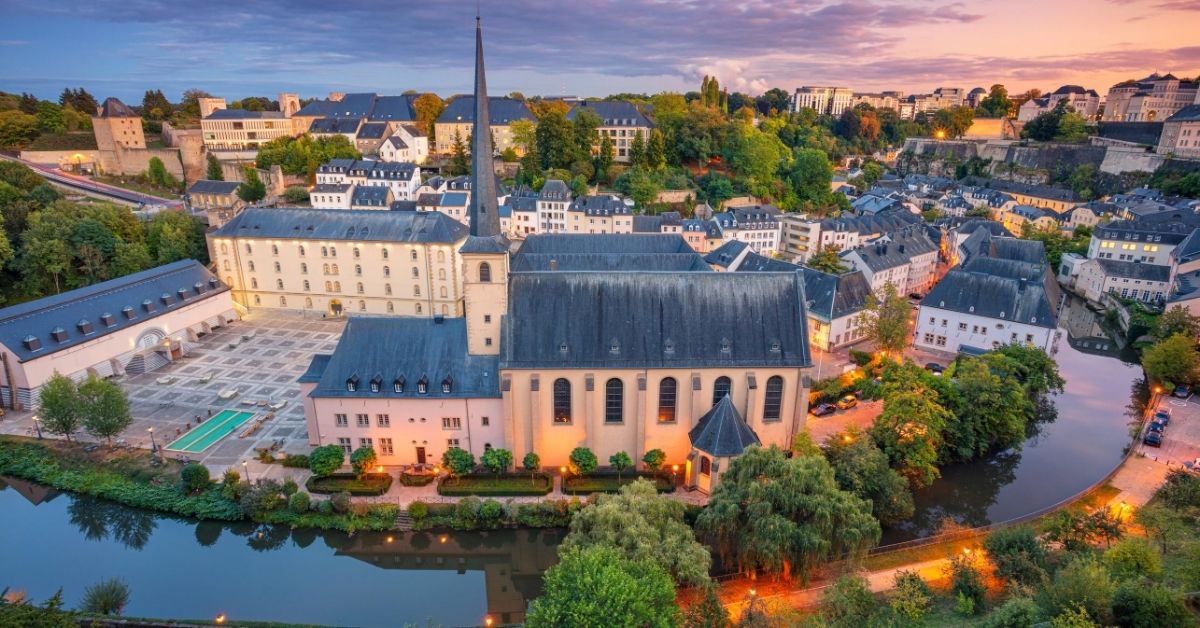 bird's eye view of historical area of Luxembourg with church illuminated at dusk