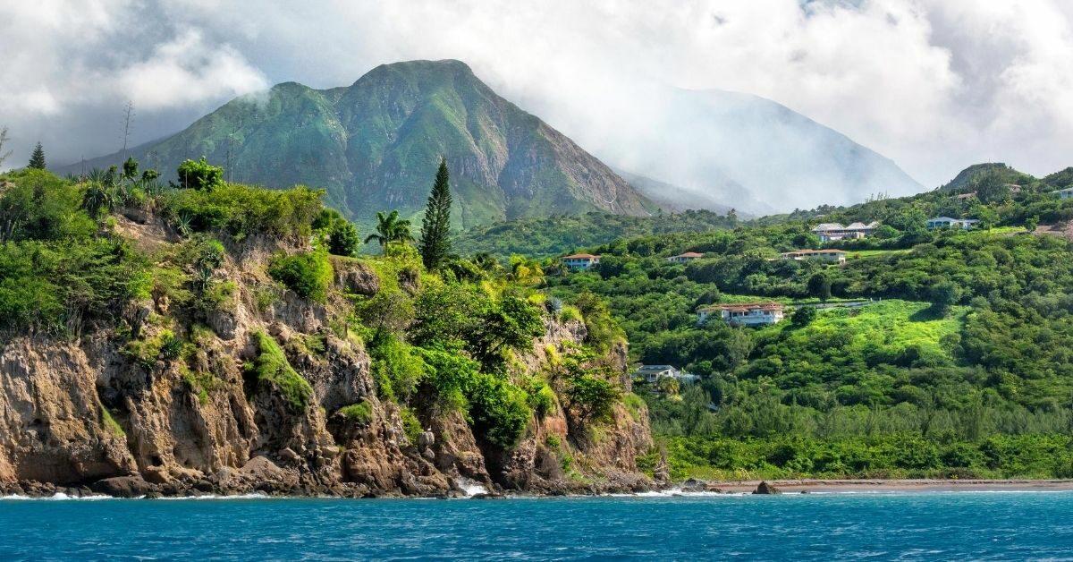 coast of Montserrat, viewed from the Caribbean with mountains, volcano and houses