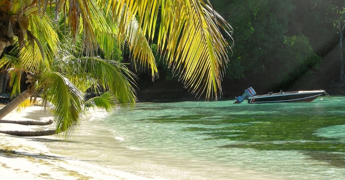 hidden beach on the private island Mustique with boat