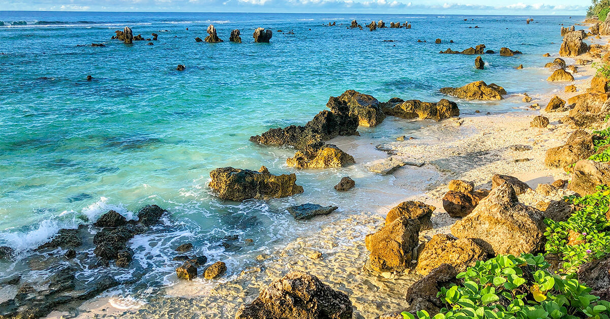 rocky beach with water in shades of blue