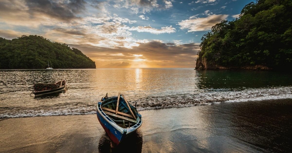 Saint Vincent and The Grenadines bay with boats on the Caribbean and the beach at sunset