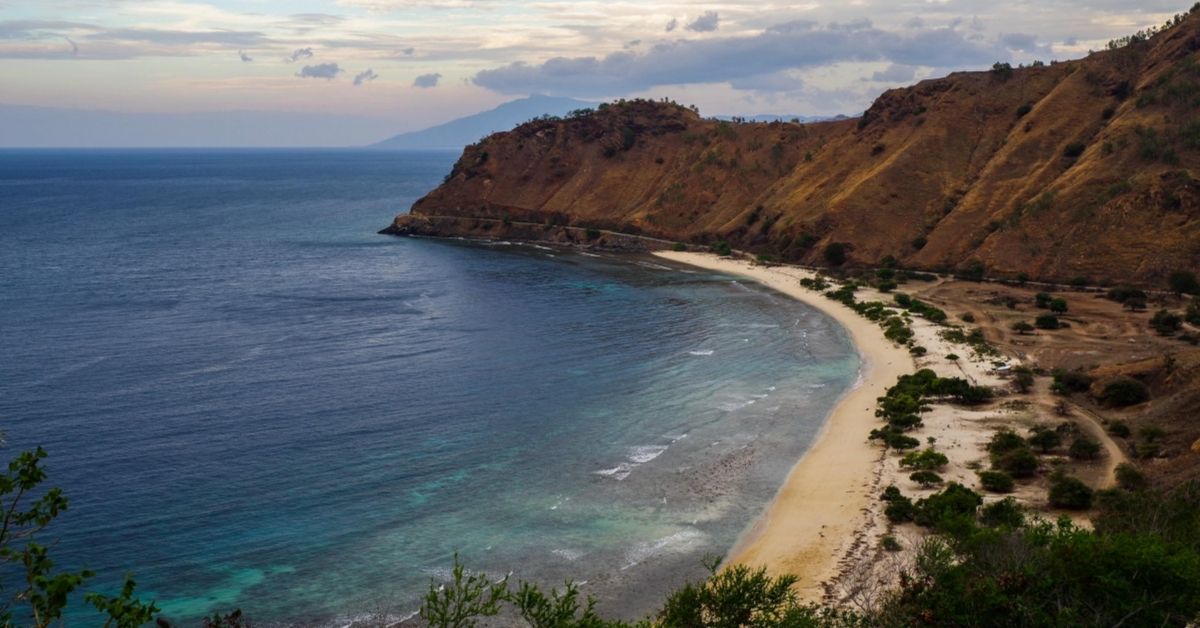mountain with beach below near Dili, Timor Leste at dusk