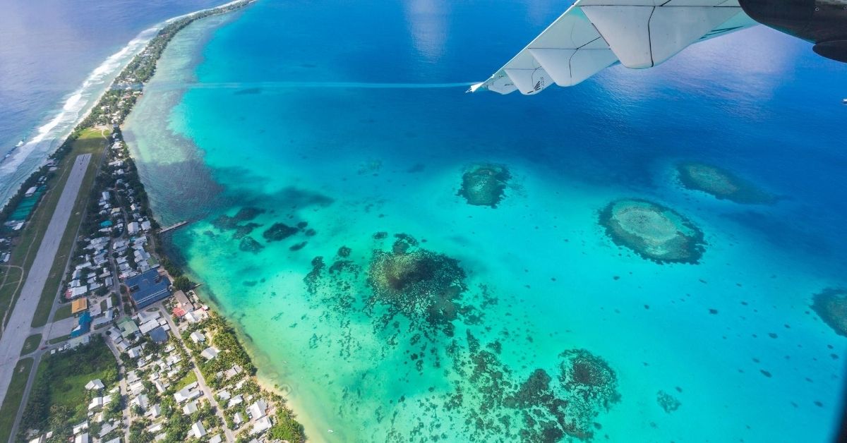 view from plane down to the island of Tuvalu with town and atolls in the Pacific