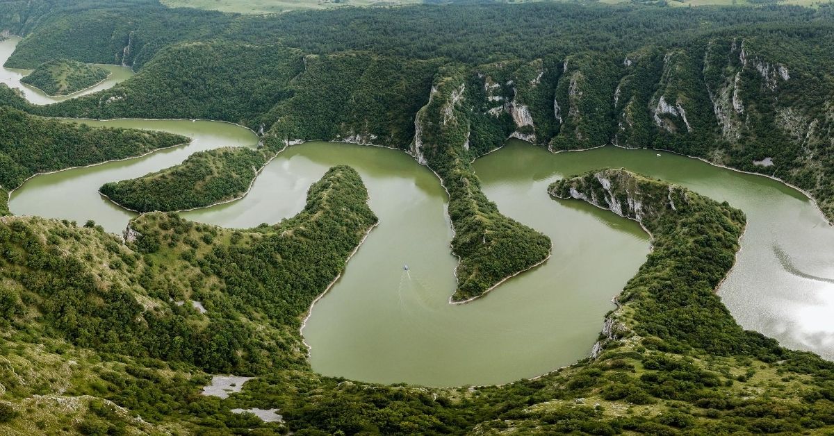 view atop mountain looking down to river winding through gorge