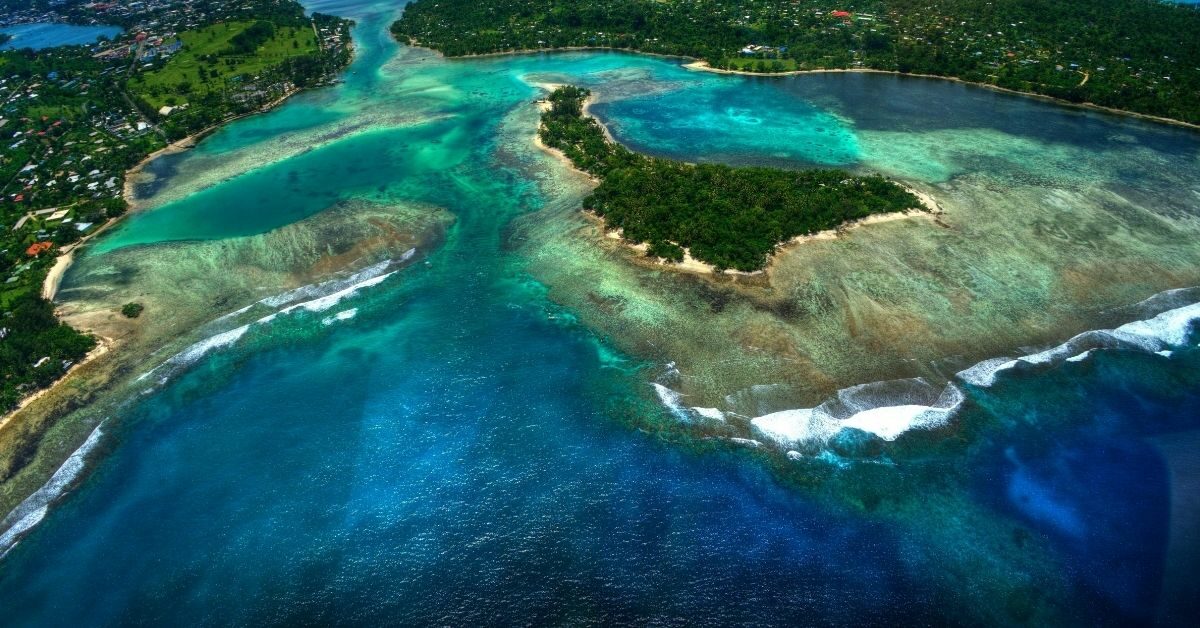 bird's eye view of Port Vila Bay with small palm tree covered island in the middle of the bay