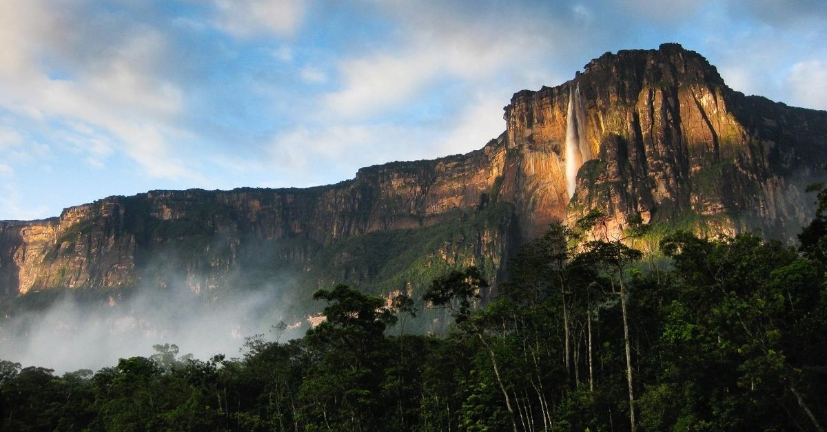 cliff face and Angel Falls at dawn with lush rainforest below