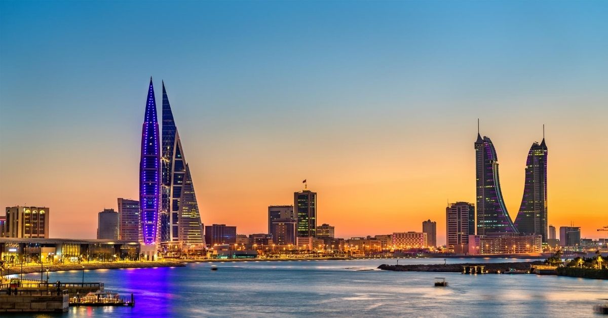 colorful Manama skyline along the coast at dusk