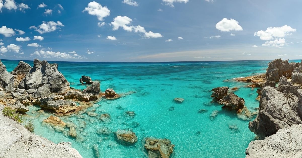 azure waters of the Atlantic ocean with rocky coast in Bermuda on a bright cloudy day
