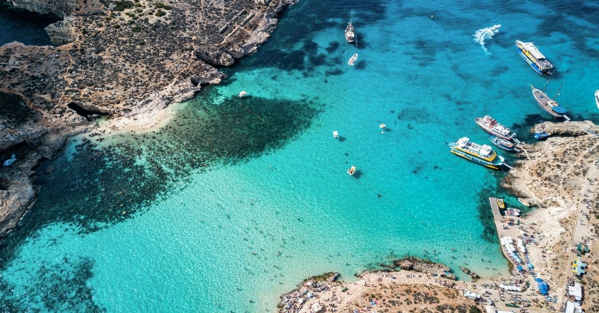 beautiful panoramic view of the blue lagoon with boats and beaches on either side