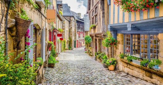 quaint village in France with cobblestone street and homes with bright colored accents