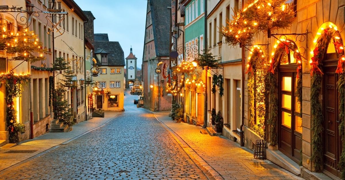 quaint medieval village street illuminated with Christmas lights