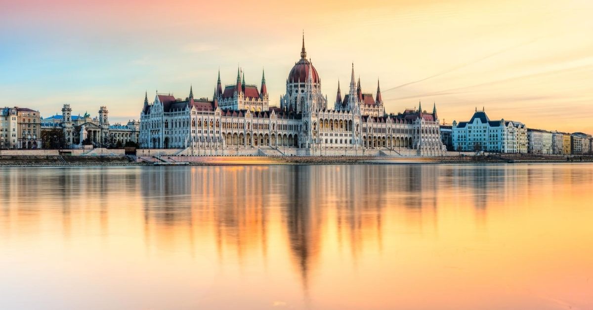 Hungarian Parliament at sunset reflected onto the River Danube