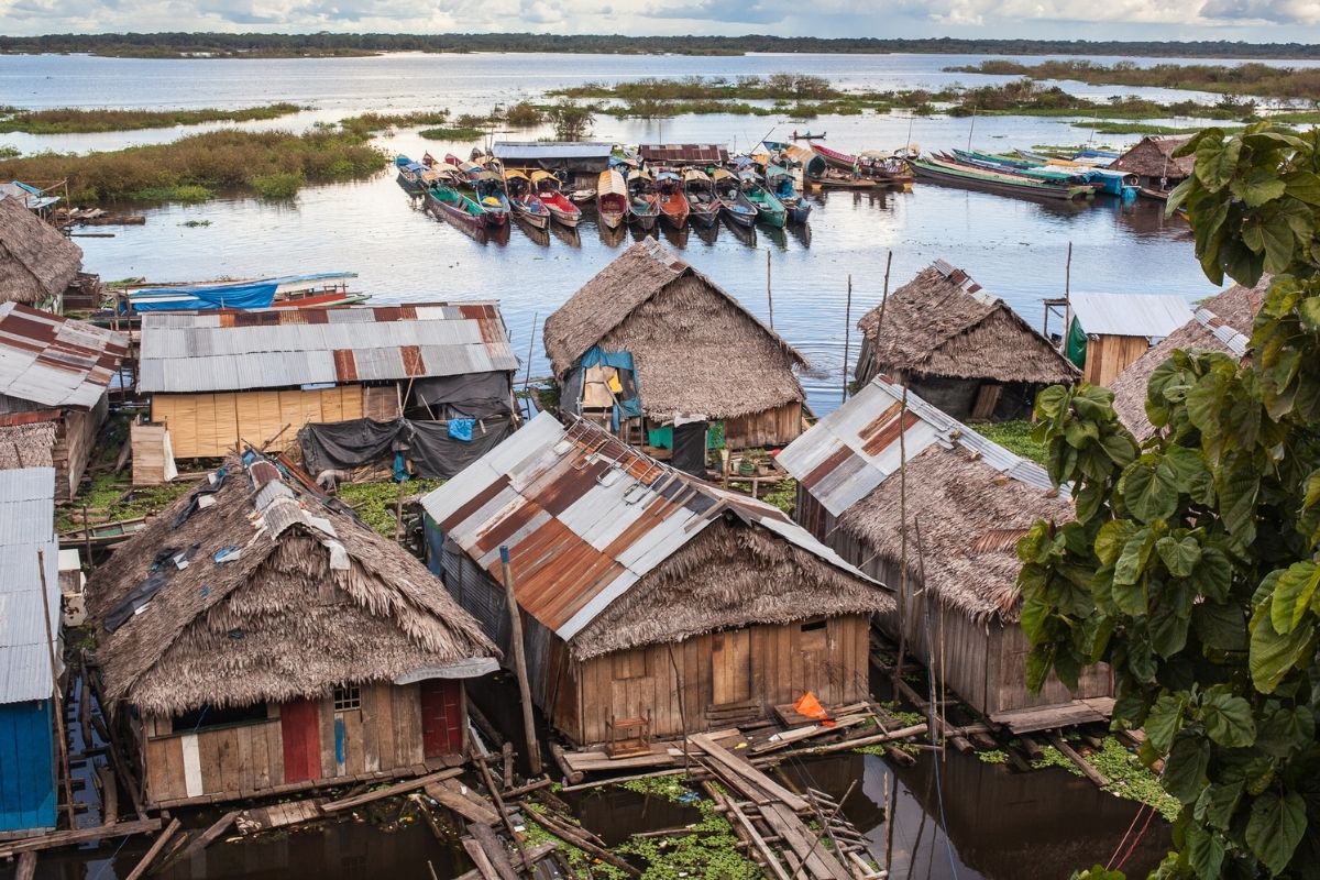 traditional houses on the river and canoes in Iquitos, Peru