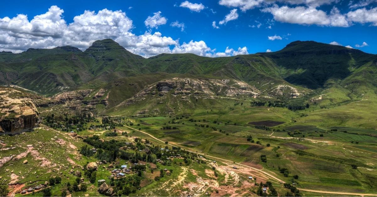 Green covered mountains with village in valley in Lesotho