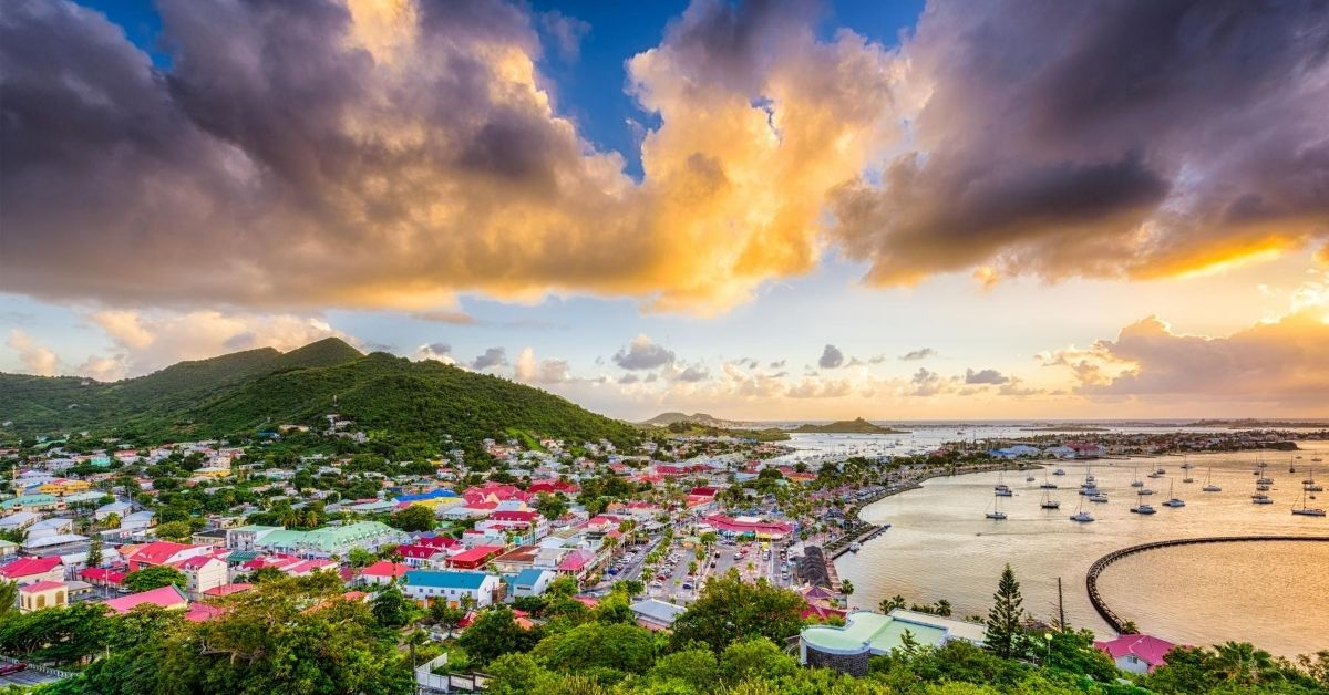 bird's eye view of Saint Martin island with colorful buildings at and the Caribbean at sunset