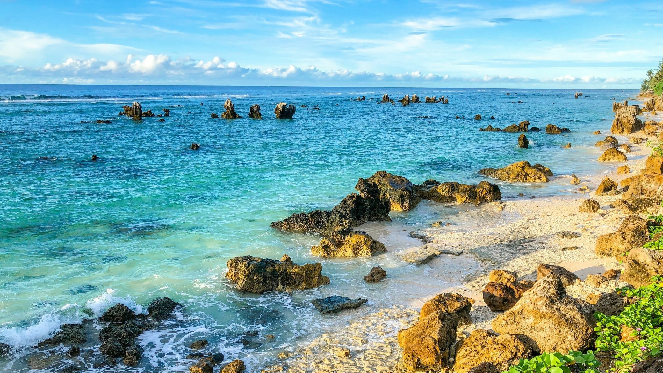 rocky beach with water in shades of blue