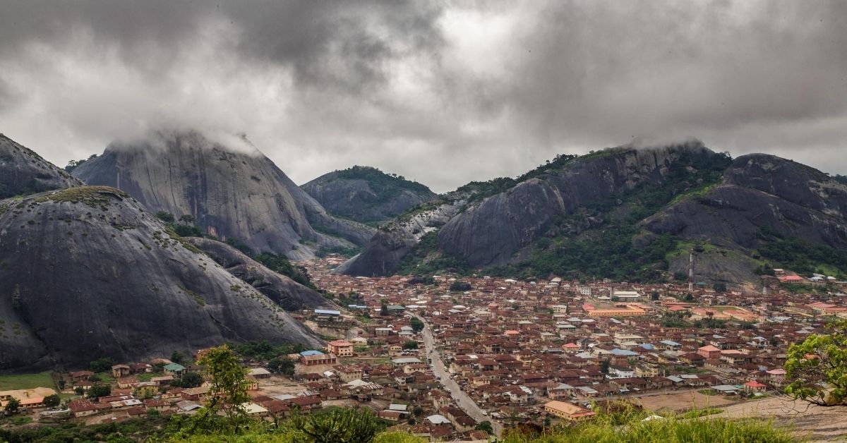 Black mountains of rock in Nigeria and valley with a town