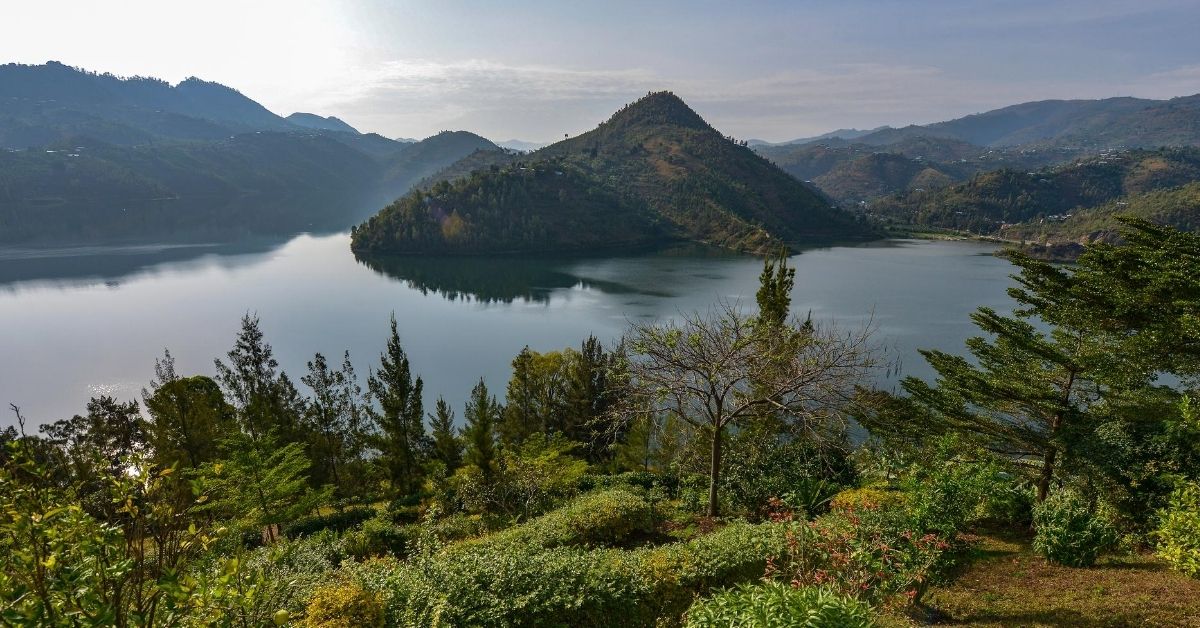 In Africa, a mountain lake with green mountainous landscape in Rwanda