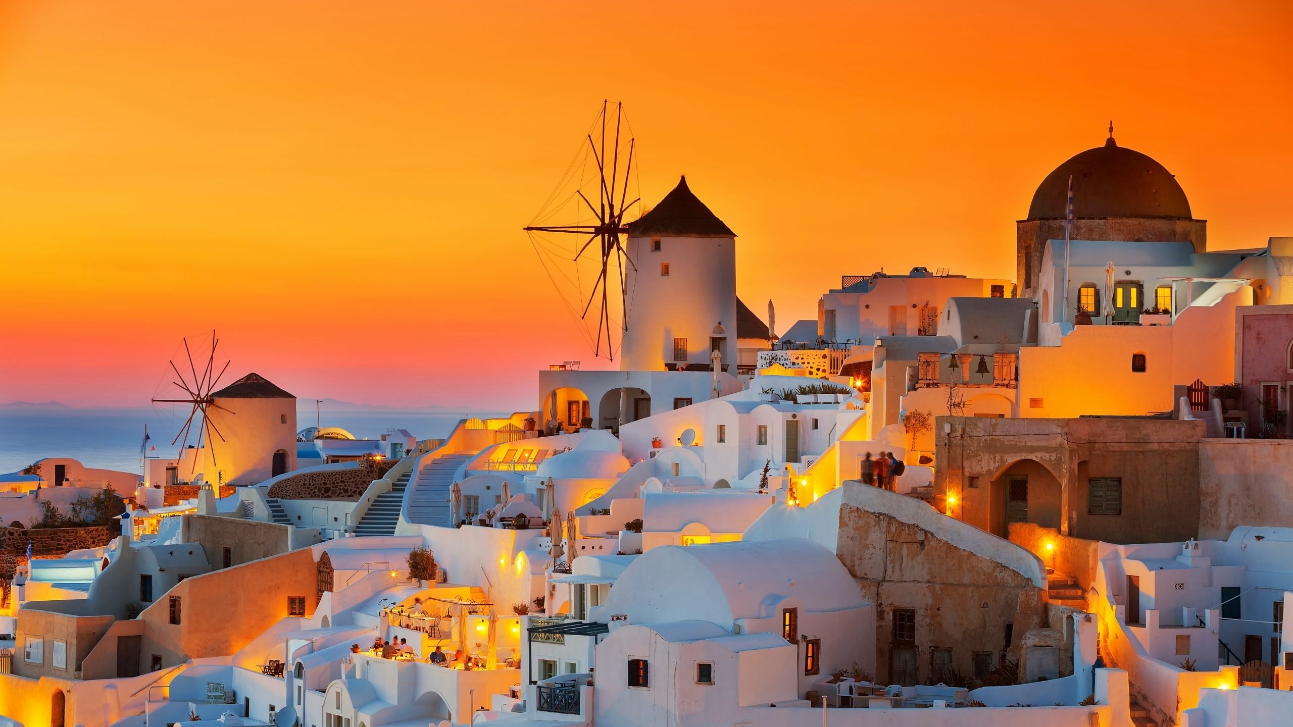 orange sunset and whitewashed houses in Oia