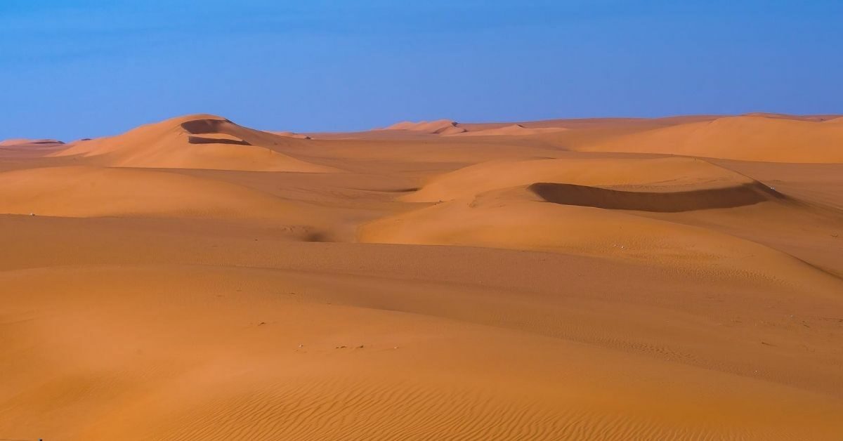 red sand dunes with blue sky