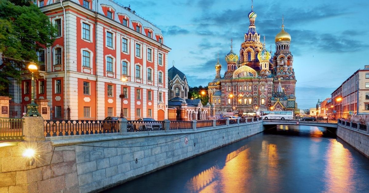 canal in with colorful church and buildings at twilight