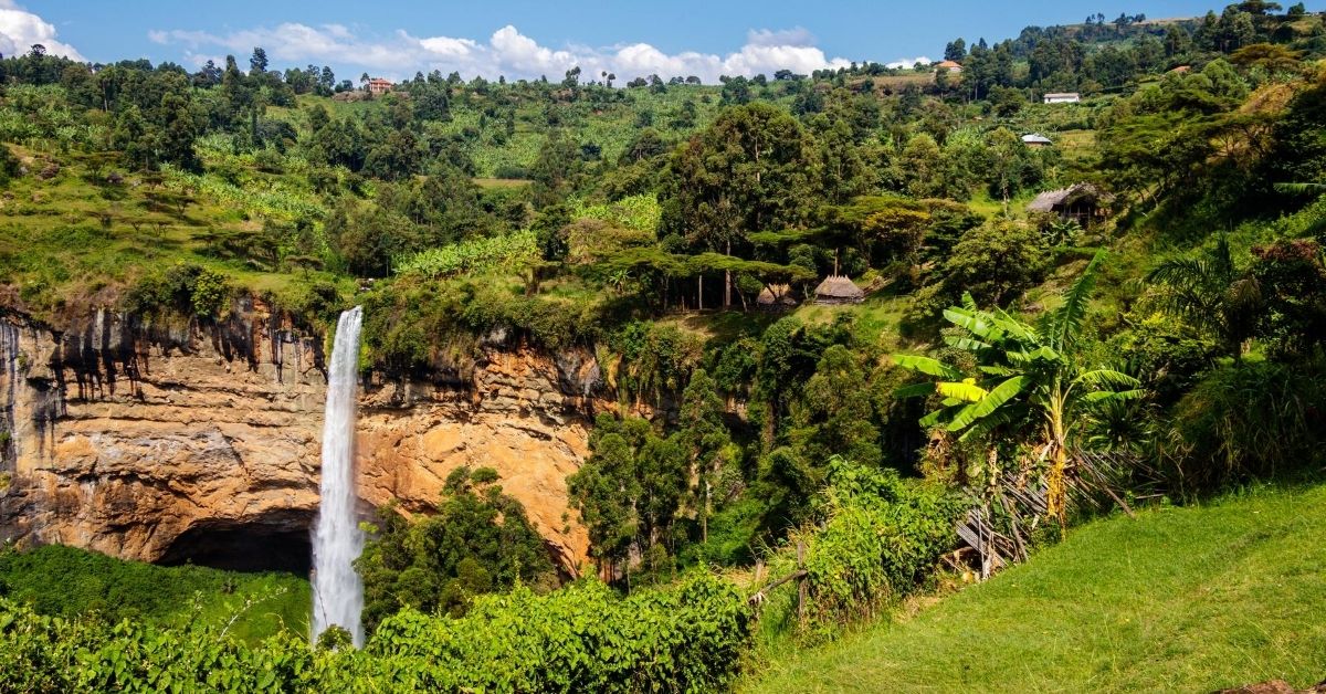 waterfall surrounded by green hills with foliage