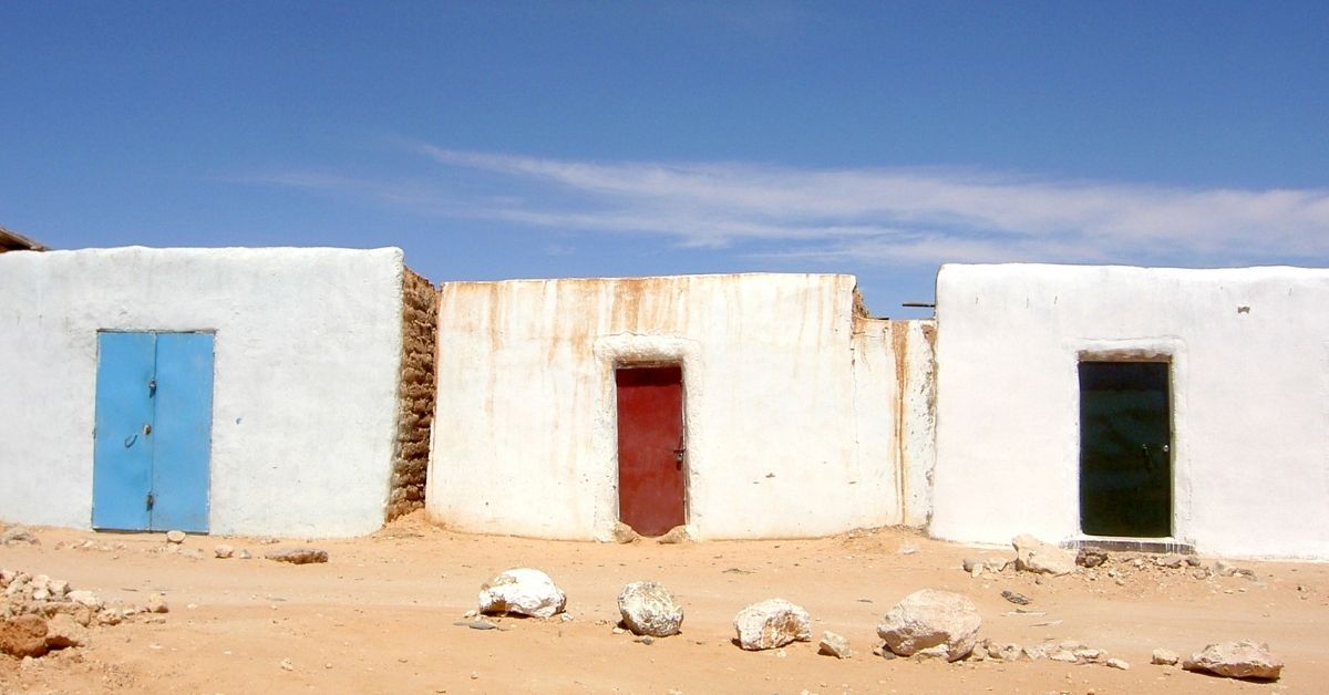 white houses with colorful doors in Tirariti, Western Sahara